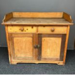 A 19th century pine kitchen cupboard/ work station Consists of two drawers and two doors with