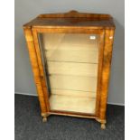 An Art Deco Burr Walnut veneer and glass section display cabinet, Supported on ball and claw feet.