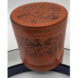 An Indian black and red lacquered preserve pot with various bowls to interior.
