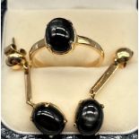 A Yellow gold ring and matching earrings fitted with silver sheen black obsidian stones. Stamped 18.