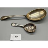 A Georgian silver caddy spoon and a sterling silver serving spoon.