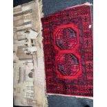 Two various ornate rugs and two ornate wall hangers.