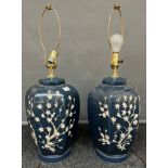 A Pair of blue table lamps with painted raised relief blossom trees [45cm high]