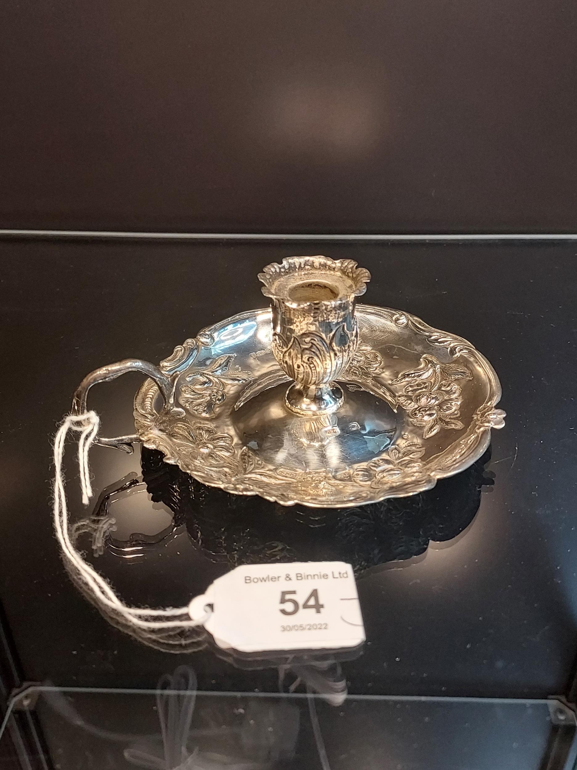 A London Import silver ornate candle holder. [79.51grams] [5cm high, 11cm diameter]