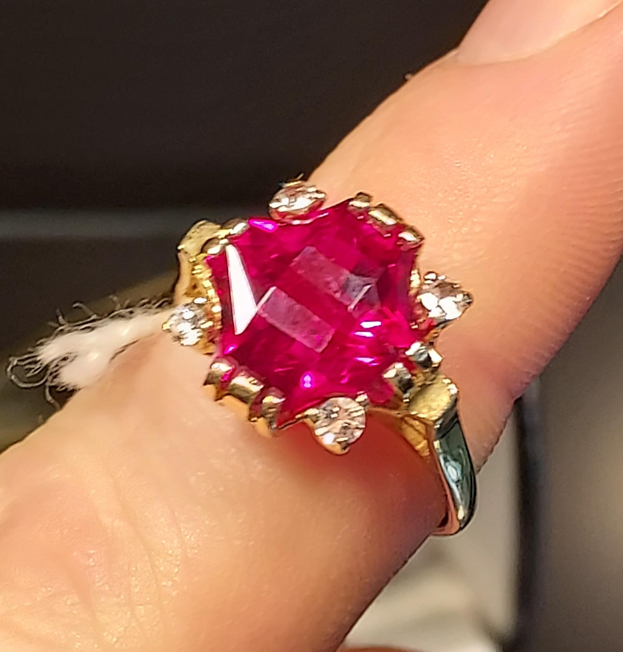 A 14ct yellow gold ring set with a large cut single ruby and four white spinel stones. [Ring size R] - Image 3 of 3