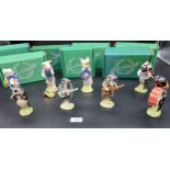 A Lot of eight Beswick pig band figures with original boxes.