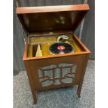 A Vintage Vokal gramophone fitted within a wooden display cabinet. In a working condition.