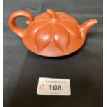 A Chinese Yixing pottery sake tea pot. [Impressed makers marks to base]
