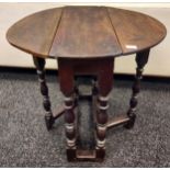 An early 17th century Tudor drop leaf table. [72cm high]