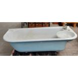 Antique cast metal and enamel bath tub with fitted taps , comes with pedestal legs.