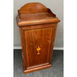 A 19th century Mahogany and boxwood strung music cabinet. The door with inlaid urn motif. [