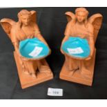 A Pair of 19th century Terracotta angel figures holding shells, Shell is finished with a blue