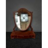 A 19th century serpentine front table top mirror. Mirror is shaped in the form of a shield. [