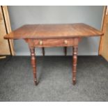 A 19th century Mahogany drop end sofa table, supported on turned legs.