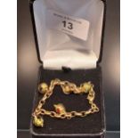 A 9ct yellow gold and Murano glass charm bracelet. [7.40grams] [16cm in length]