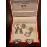 A Ladies 925 silver ring set with a square cut blue topaz off set by smaller white topaz stones,