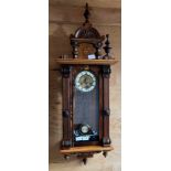 Antique ornate wall clock, designed with marquetry trims, Showing a brass face and enamel roman