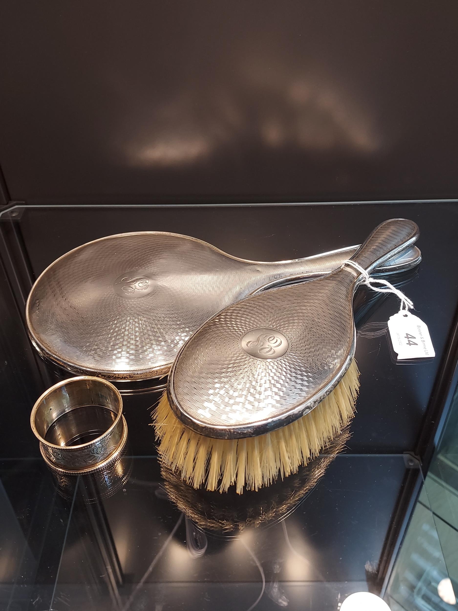 A Birmingham silver hand mirror and brush together with a Chester silver napkin ring