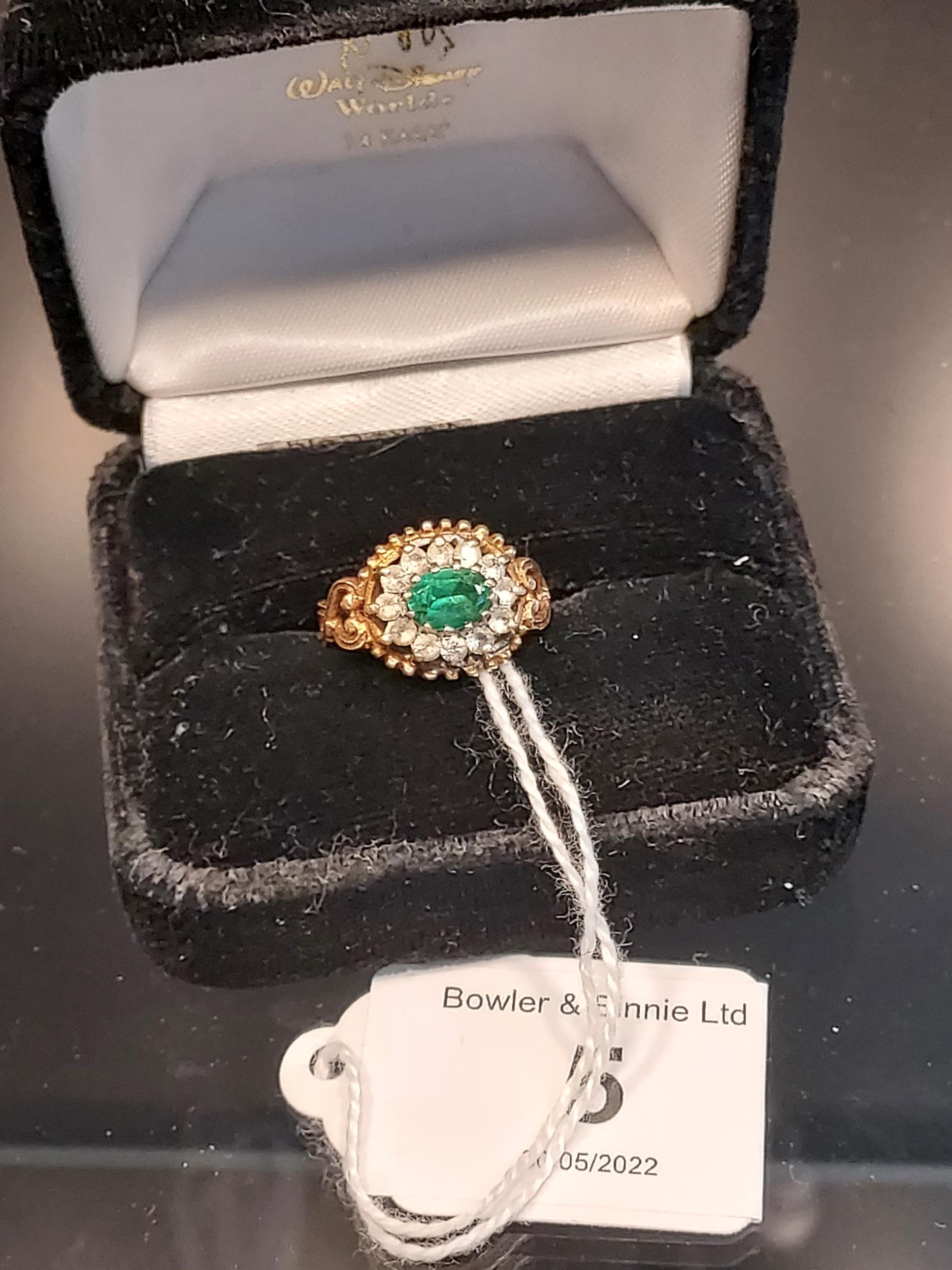 A Sheffield 9ct yellow gold ring set with a single green spinel surrounded by white spinel