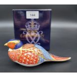 A Royal Crown Derby Pheasant paperweight. Gold button and comes with original box.