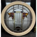 A cast iron circular surround fitted with a stained glass panel. Possibly from a ship [In an art