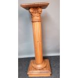 Carved wooden torcher stand, the square top above a carved floral/foliage section, leading to a