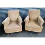 Two contemporary arm chairs, the whole covered in a neutral upholstery, raised on turned legs and
