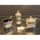 A Birmingham silver Three piece condiment set produced by Adie Brothers Ltd. Has original blue