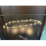 A 9ct white gold and pearl necklace [38cm in length] [7.50grams]