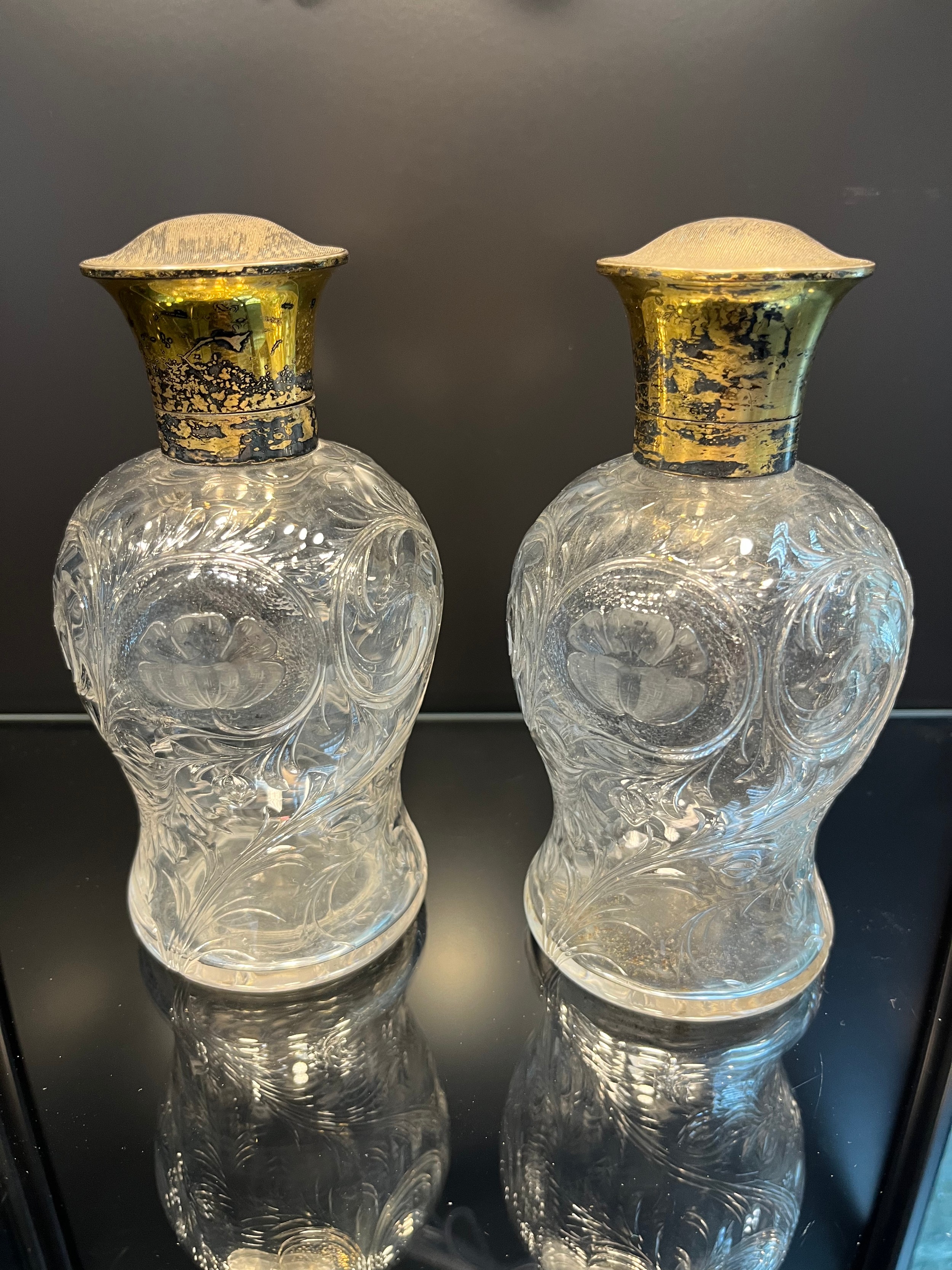 A Pair of London silver gilt topped and cut crystal perfume bottles. [16.5cm high] [One As Found]