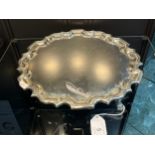 A Sheffield silver three foot serving tray, designed with a pie crust edge. Produced by