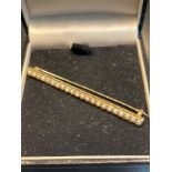 A 14K yellow gold and seed pearl bar brooch [4.12grams] [6.3cm in length]