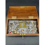 A Box of military collectables to include Bosson whistle, British Legion belt Buckle and badges.