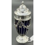 A London silver and blue glass pierced sugar shaker. [14.5cm high]