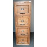 Oak filing unit, the rectangular top above and bank of four drawers, plaque to the base [W.