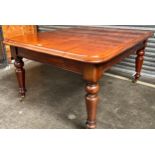 A 19th century mahogany Dining table. Supported on turned legs and castors. [75X155X115CM]