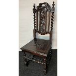 Jacobean style chair, the highly carved back with foliage design above a carved seat, supported with