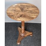 Antique rosewood tilt top table, the circular surface above a turned column support, raised on a tri