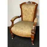 Antique parlour chair, the shaped cushioned back above open arm padded supports and a cushioned seat