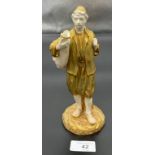 A Royal Worcester man carrying an urn figure. [20cm high]