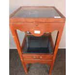 Antique mahogany display unit, the lift-up glass top above a carved moulded apron and glass top