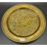 A Brass Arts and Crafts raised relief wall charger [45.5cm diameter]