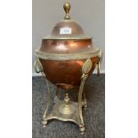 Antique brass and copper urn, detailed with ram head and ring sculpt handles.[46cm high]