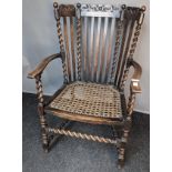 Antique oak chair, the high back with moulded and carved extension and turned and splat back,