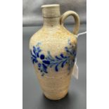 An early 19th century stone ware salt glaze flagon detailed with blue decoration. [18cm high]