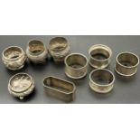 Five silver marked napkin rings, Silver Birmingham salt pot designed on three bun feet. Three