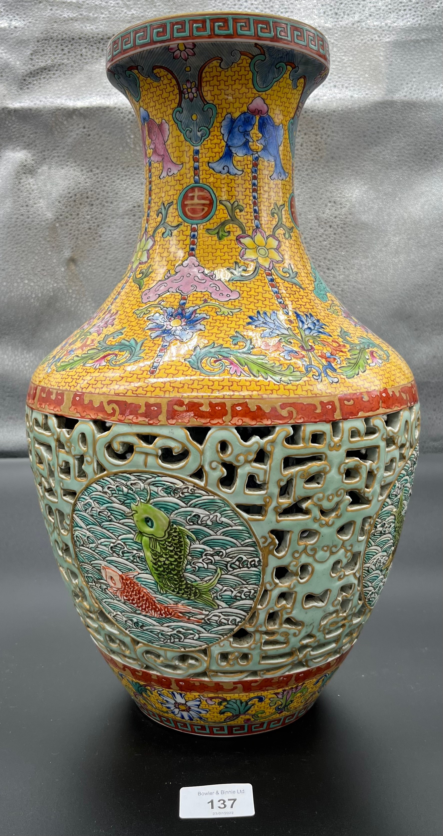 A Chinese Qianlong era marked vase. Yellow ground and pierced blue ground, Four panels depicting