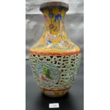 A Chinese Qianlong era marked vase. Yellow ground and pierced blue ground, Four panels depicting