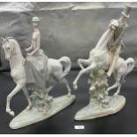 A Large pair of Lladro figurines- man and women on horse back. [49cm high]