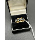 A ladies 14ct gold [585] ring set with three large Sapphires [each measure 5.25mm]surrounded by